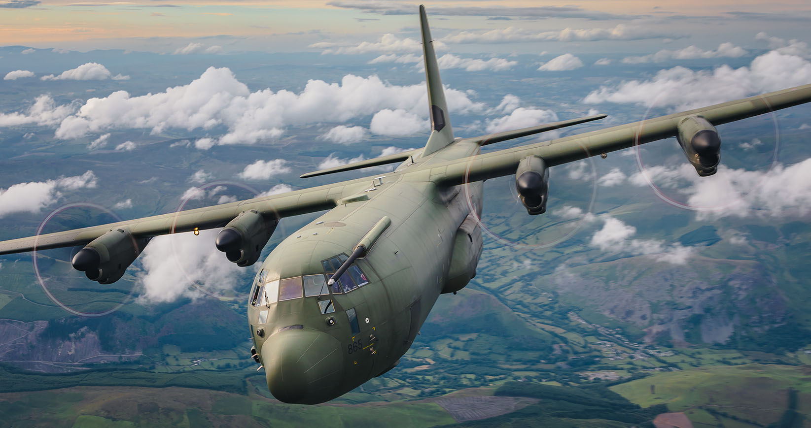 Image shows the RAF Hercules in flight through the clouds.